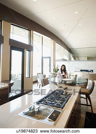 Stock Image - Woman in home interior. Fotosearch