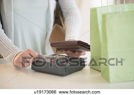 Woman paying with credit card View Large Photo Image Stock Photograph - Woman paying with credit card. Fotosearch