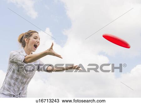 Woman playing with frisbee View Large Photo Image Stock Image - Woman playing with frisbee. Fotosearch