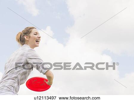 Woman playing with frisbee View Large Photo Image Stock Photo - Woman playing with frisbee. Fotosearch