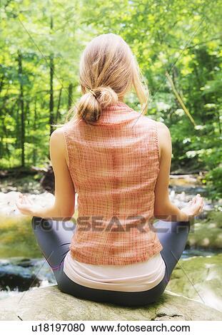 Woman practicing joga in forest View Large Photo Image Stock Image - Woman practicing joga in forest. Fotosearch