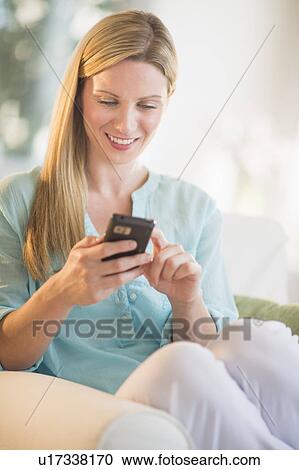Stock Image - Woman texting on phone. Fotosearch
