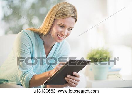 Woman using tablet pc View Large Photo Image Stock Image - Woman using tablet pc. Fotosearch