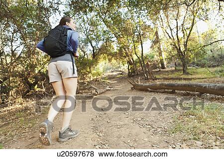 Stock Photo - Woman with backpack on track. Fotosearch