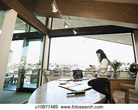 Stock Photo - Woman working from home. Fotosearch