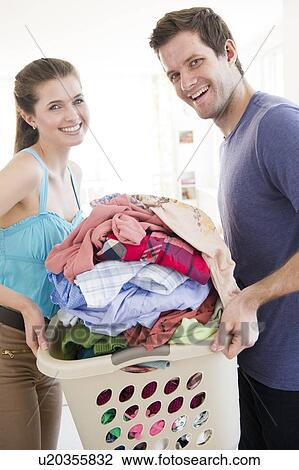 Young couple doing laundry View Large Photo Image Stock Image - Young couple doing laundry. Fotosearch