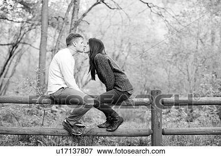 Stock Photo - Young couple kissing. Fotosearch