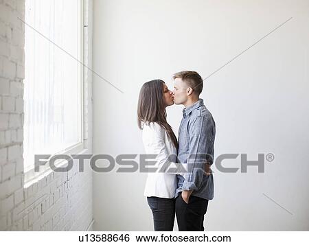 Young couple kissing View Large Photo Image Stock Photograph - Young couple kissing. Fotosearch