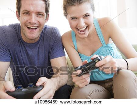 Young couple playing computer games View Large Photo Image Stock Photo - Young couple playing computer games. Fotosearch