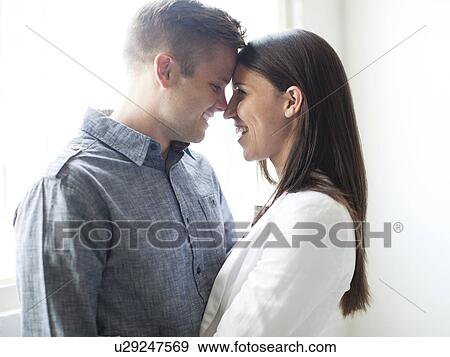 Stock Photo - Young couple standing face to face. Fotosearch