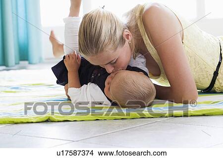 Young mother kissing daughter View Large Photo Image Picture - Young mother kissing daughter. Fotosearch
