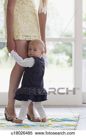 Young mother supporting daughter with her first steps View Large Photo Image Stock Photography - Young mother supporting daughter with her first steps. Fotosearch