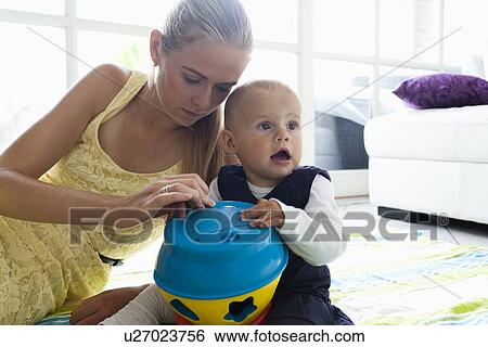 Stock Photograph - Young mother with daughter playing. Fotosearch