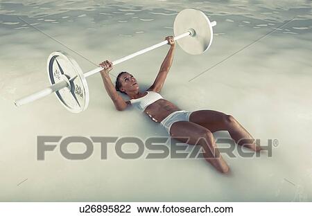 Young woman weight lifting in water View Large Photo Image Stock Image - Young woman weight lifting in water. Fotosearch