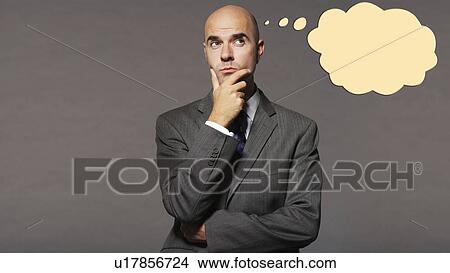 Bald businessman thinking with speech bubble over gray background View Large Photo Image Picture - Bald businessman thinking with speech bubble over gray background. Fotosearch