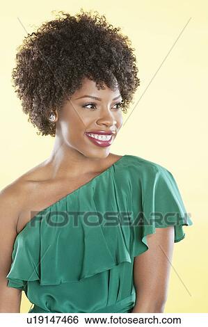 Beautiful African American in an off shoulder dress looking away over colored background View Large Photo Image Stock Photograph - Beautiful African American in an off shoulder dress looking away over colored background. Fotosearch