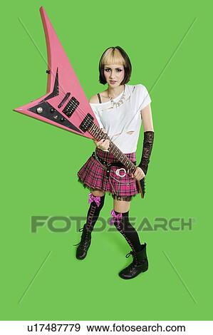 Beautiful punk woman with guitar over green background View Large Photo Image Stock Photo - Beautiful punk woman with guitar over green background. Fotosearch