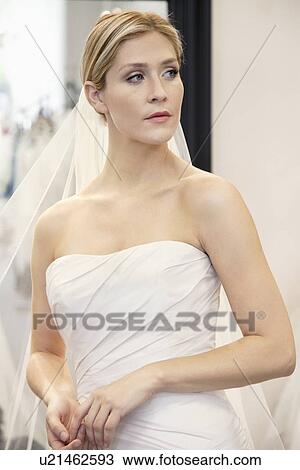 Beautiful young woman dressed up in wedding gown looking away View Large Photo Image Stock Image - Beautiful young woman dressed up in wedding gown looking away. Fotosearch