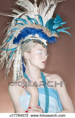 Beautiful young woman wearing feather headgear with eyes closed View Large Photo Image Stock Image - Beautiful young woman wearing feather headgear with eyes closed. Fotosearch