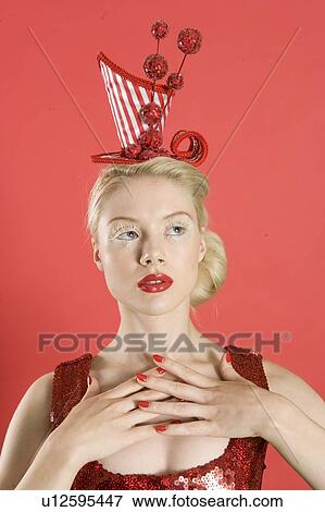 Beautiful young woman wearing red headgear over colored background View Large Photo Image Stock Photo - Beautiful young woman wearing red headgear over colored background. Fotosearch