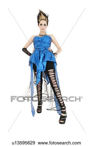 Beautiful young woman wearing ripped dress with spiked hairstyle over white background View Large Photo Image Stock Photo - Beautiful young woman wearing ripped dress with spiked hairstyle over white background. Fotosearch