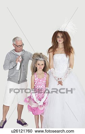 Bride and bridesmaid with makeup artist over light gray background View Large Photo Image Stock Image - Bride and bridesmaid with makeup artist over light gray background. Fotosearch