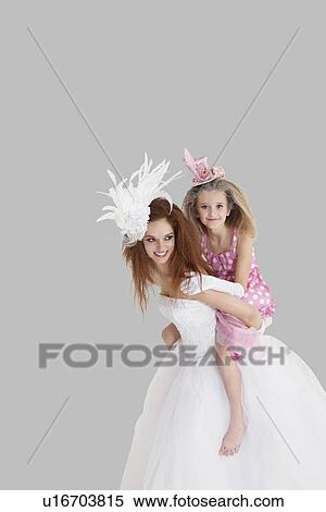 Bridesmaid getting a piggyback ride from young bride over gray background View Large Photo Image Stock Photography - Bridesmaid getting a piggyback ride from young bride over gray background. Fotosearch