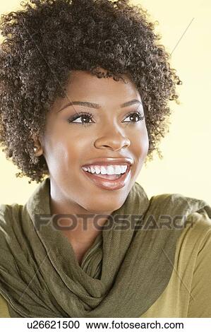Cheerful African American woman looking away over colored background View Large Photo Image Stock Image - Cheerful African American woman looking away over colored background. Fotosearch
