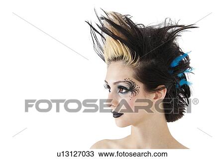 Close-up of beautiful gothic woman with spiked hair and face painting over white background View Large Photo Image Stock Image - Close-up of beautiful gothic woman with spiked hair and face painting over white background. Fotosearch