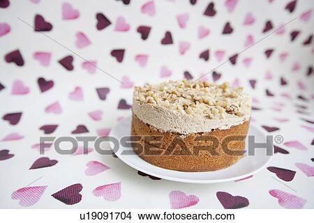 Picture - Close-up of birthday cake over heart shaped background. Fotosearch