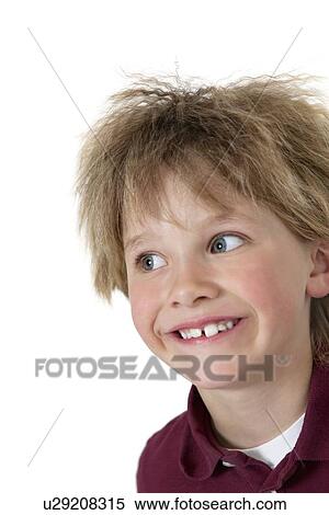 Stock Photography - Close-up of blond boy looking sideways over white background. Fotosearch