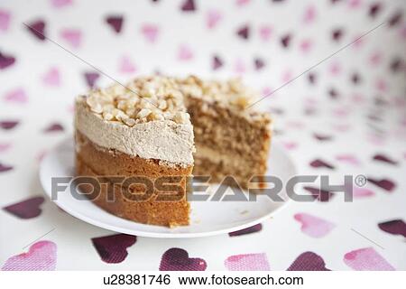 Stock Photograph - Close-up of cake with missing piece over heart shaped background. Fotosearch