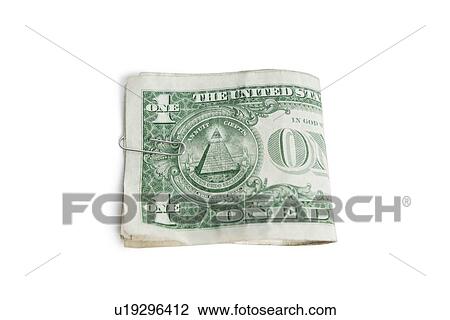 Stock Image - Close-up of paper dollars in clip over white background. Fotosearch