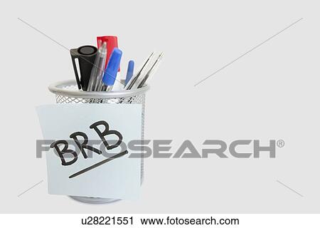 Stock Image - Close-up of sticky note with message on pen holder over white background. Fotosearch