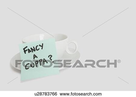 Stock Photograph - Close-up of sticky notepad stuck to empty coffee cup over white background. Fotosearch