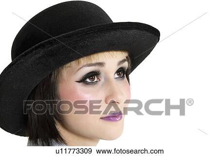 Stock Photo - Close-up of young woman wearing hat over white background. Fotosearch