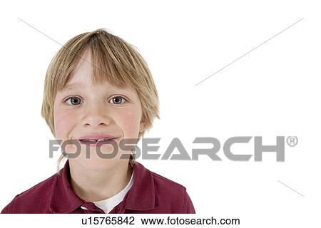 Stock Image - Close-up portrait of a happy school boy over white background. Fotosearch