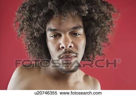 Close-up portrait of a young man with curly hair over colored background View Large Photo Image Stock Photography - Close-up portrait of a young man with curly hair over colored background. Fotosearch