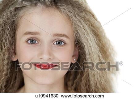 Stock Image - Close-up portrait of blond girl wearing red lipstick. Fotosearch
