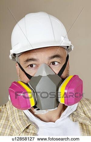 Close-up portrait of contractor with dust mask over colored background View Large Photo Image Stock Photo - Close-up portrait of contractor with dust mask over colored background. Fotosearch