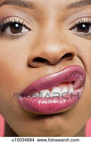 Close-up portrait of young woman with pink lips grimacing View Large Photo Image Picture - Close-up portrait of young woman with pink lips grimacing. Fotosearch