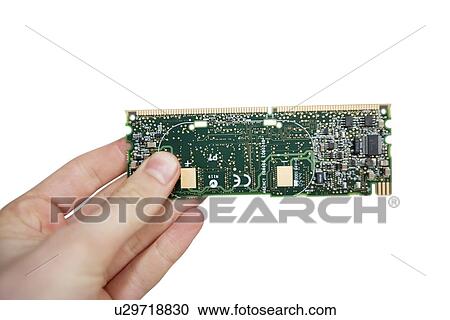 Stock Image - Close-up view of hands holding computer circuit board over white background. Fotosearch