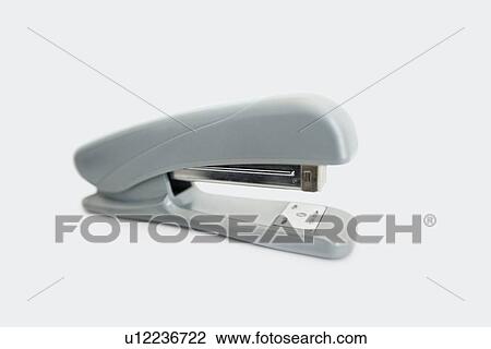 Stock Image - Close-up view of office stapler over white background. Fotosearch