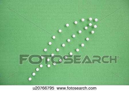 Stock Photography - Close-up view of push pins forming leaf over colored background. Fotosearch