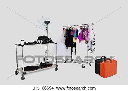 Clothes rack and reflector umbrella with suitcase in studio View Large Photo Image Picture - Clothes rack and reflector umbrella with suitcase in studio. Fotosearch
