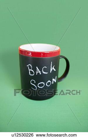 Stock Photograph - Coffee mug with text over colored background. Fotosearch