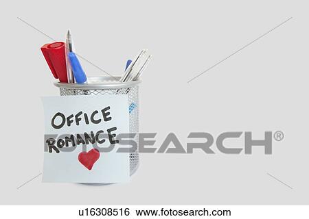 Stock Photograph - Conceptual image of sticky notepaper with heart shape depicting office romance. Fotosearch