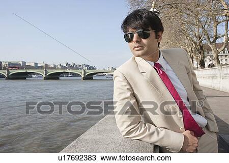 Confident Indian business executive standing with hands in pockets View Large Photo Image Stock Image - Confident Indian business executive standing with hands in pockets. Fotosearch