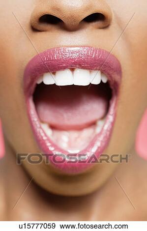 Cropped image of African American woman with mouth open View Large Photo Image Stock Photo - Cropped image of African American woman with mouth open. Fotosearch