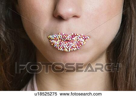Cropped image of candy sprinkled lips woman View Large Photo Image Stock Photography - Cropped image of candy sprinkled lips woman. Fotosearch